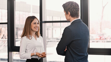 businessman listening to smiling woman talking during job interview.
