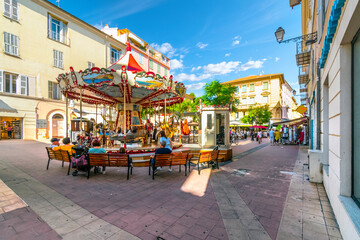 A carousel merry-go-round in a small square in the old town section of Menton, France, along the...
