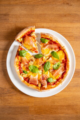 tasty pizza on the wooden background