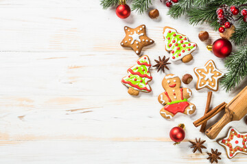 Christmas gingerbread with decorations on white wooden table. Christmas baking. Top view with copy space.