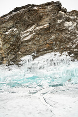 Fototapeta na wymiar icicles on the rocks on the Lake Baikal