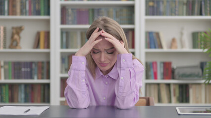 Upset Woman Feeling Worried While Sitting in Office