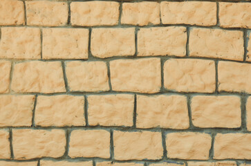 Close-up of a fragment of an old brick wall made of white limestone. yellow decorative kirchik. background