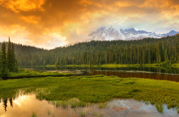 Beautiful sunset over MT Rainier with reflection viewing from Reflection lake, MT Rainier National Park, Washington. Tranquil lakes known for wildflowers and mirror images of picturesque Mount Rainier