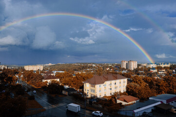 Beautiful bright double rainbow over the small city