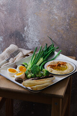 Breakfast with backed meat, hummus and green vegetables, copy space - 528565107