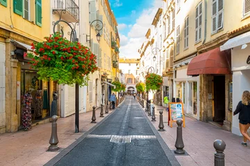 Zelfklevend Fotobehang A picturesque street through the old town center of Antibes, France, in the Cote d'Azur, French Riviera region along the Mediterranean Sea. © Kirk Fisher