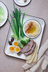 Breakfast with backed meat, hummus and green vegetables, copy space - 528565332