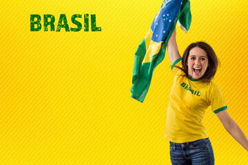 Female brazilian fan celebrating on a yellow background.