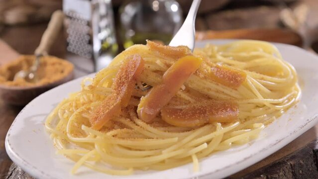 Spaghetti with bottarga. Typical Sardinian Cuisine. A dish with traditional Italian pasta from the South, dried sardine roe, lemon and pasta. High quality 4k footage