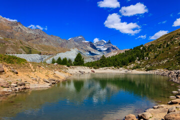 View of Grunsee lake (Green Lake) and the Swiss Alps at summer on the Five Lakes Trail in Zermatt, Switzerland