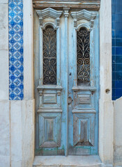 Lisbon, Portugal, October 24, 2021: view of old blue wooden door with ceramic tiles at Lisbon...