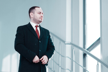A man in business suit on stairs.