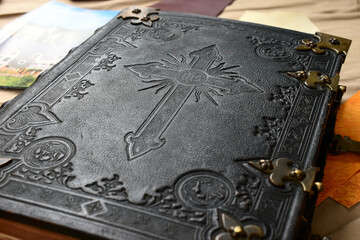old  holy bible book cover with cross symbol