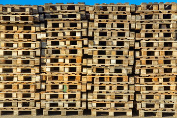 Stacks of wooden pallets in a warehouse yard of factory.