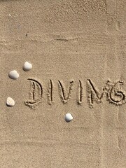 on the beach is carved with letters in the smooth sand the writing diving
