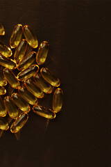 Fish oil pills. Omega 3 gel capsules on black background