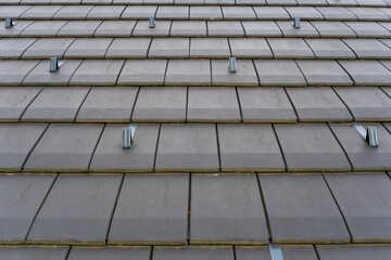 Roof with modern tiles and snow fasteners.