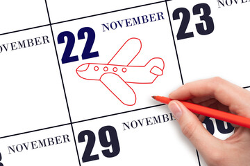 A hand drawing outline of airplane on calendar date 22 November. The date of flight on plane.