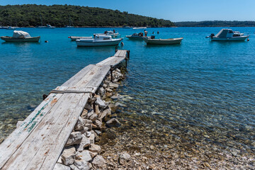 boats on the wooden pier in pula, croatia