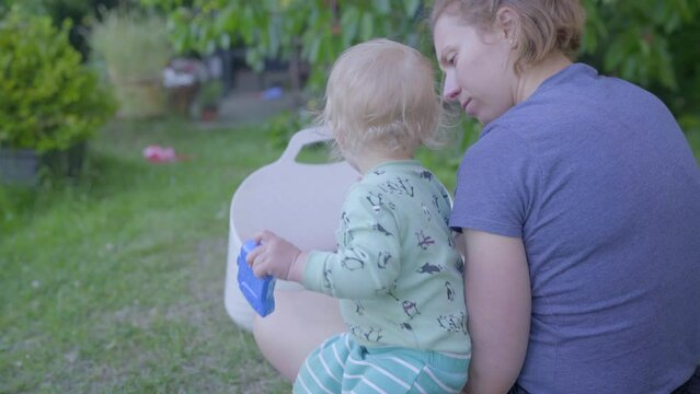 Cute Baby Boy And Woman Eating Cherries Together On Grass In Backyard - Jablonec nad Nisou, Czech Republic