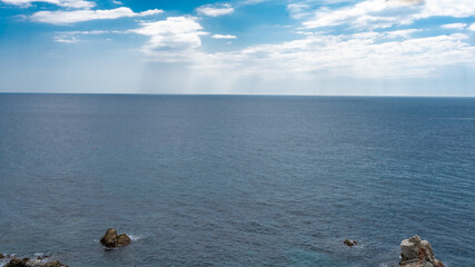
blue ocean, horizon and the blue sky from the coast in summer - 528576362