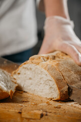 Male chef's hands cut bread