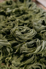 Flat lay top view fettuccine pasta. Nest-shaped noodles close-up: fettuccine, ramen, soba, rice noodle, egg noodle, green noodle