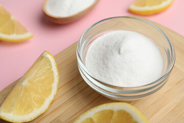 Baking soda and lemons on pink background, closeup