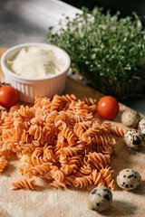 Background texture of tricolor fusilli pasta for traditional Italian and Mediterranean cuisine in a close up full frame view