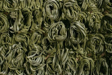 Flat lay top view fettuccine pasta. Nest-shaped noodles close-up: fettuccine, ramen, soba, rice noodle, egg noodle, green noodle