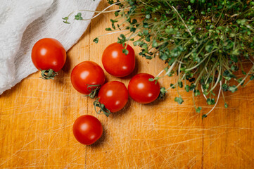 Healthy micro greens cultivated in glass container with tomatoes