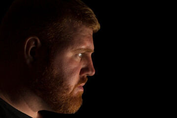 Adult Caucasian male side head shot and looking straight ahead with an expressionless face.