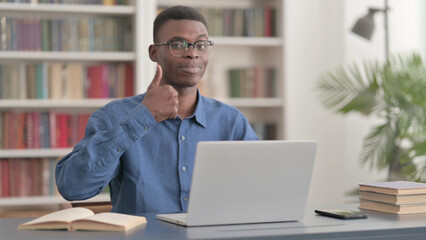 Young African Man Showing Thumbs Up While using Laptop