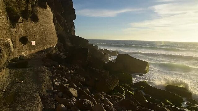 Ocean waves crashing on the rocks in Azenhas do Mar, Portugal