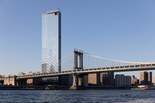 Skyscraper building towering over Manhattan Bridge
