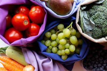 tomatoes, grapes, onions, carrots, zucchini in a bag