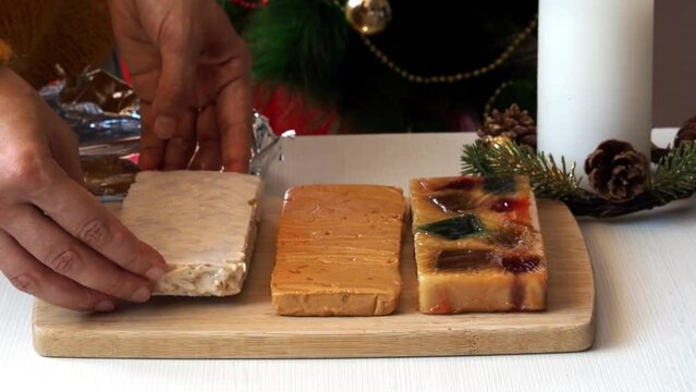 Spanish turron, hard almond, soft almond and nougat with fruits on wooden cut board