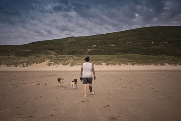 Man walking his dogs in Woolacombe