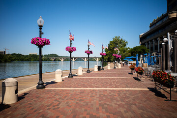 The walk path along the Potomac River, with clear blue sky, just outside the Swedish Embassy in...