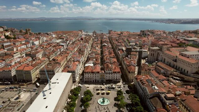 Aerial drone reveal of Baixa District in Lisbon, Portugal with major landmarks visible including Rossio Square