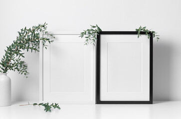 Botanical frames mockup in white room interior with green eucalyptus twigs decor