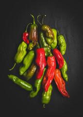 Pepperoncini peppers on a dark surface