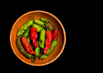 Pepperoncini peppers on a dark surface