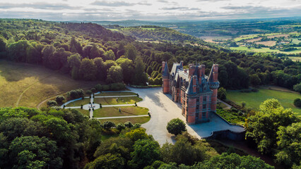 Aerial view of the Castle of Trévarez in Brittany, France - Red brick neo-gothic mansion built on a hillside in a beautiful domain with French classical gardens - obrazy, fototapety, plakaty