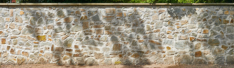 Rustic quarry stone facade with beautiful shadow.