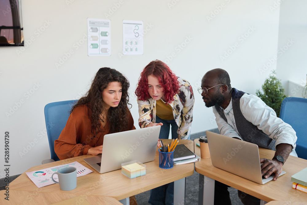 Poster group of young multicultural coworkers in casualwear consulting about new business project while pre