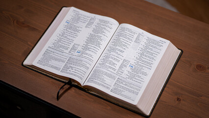 Bible open sitting in the middle of a table