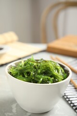 Japanese seaweed salad served on light marble table