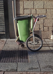 Street sweeper cart with green dumpster and sweep